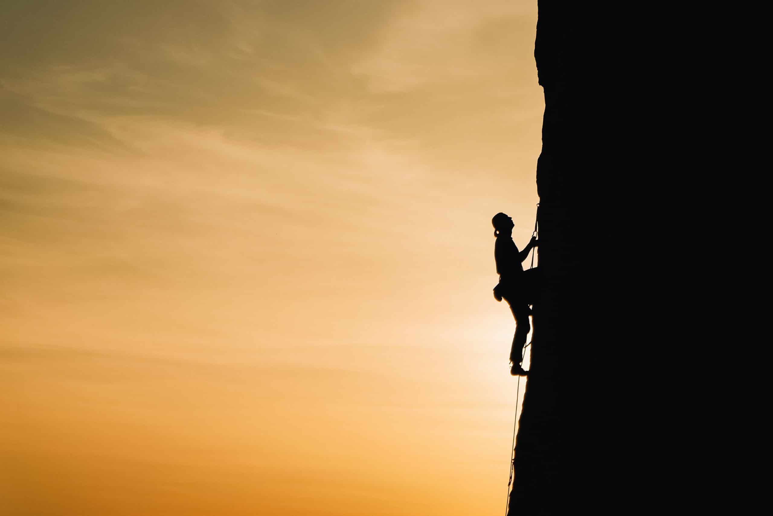 woman climbing mountain