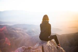 woman sitting and wondering how to feel alive
