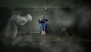 man sitting in a room battling his biggest demons