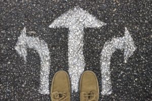 two brown shoes standing on cement