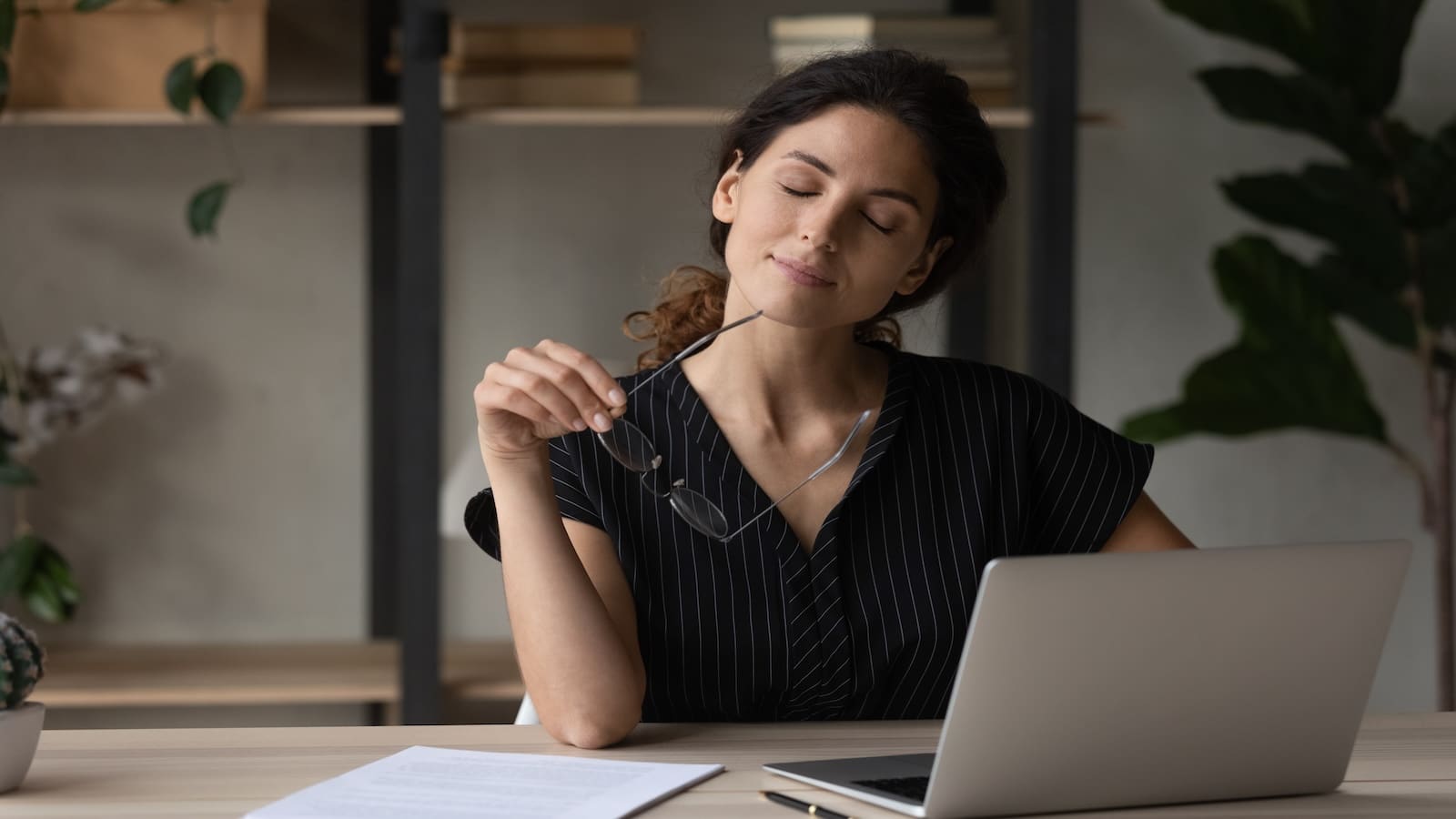 Woman practicing mindfulness meditation visualization in office.
