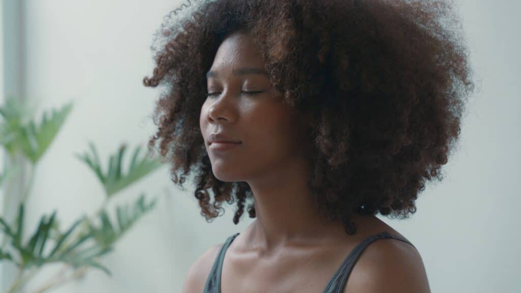 Woman practicing deep breathing meditating yoga.