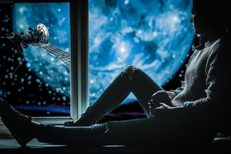 man feeling unfulfilled staring out the window