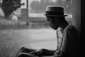 man sitting down and experiencing pain