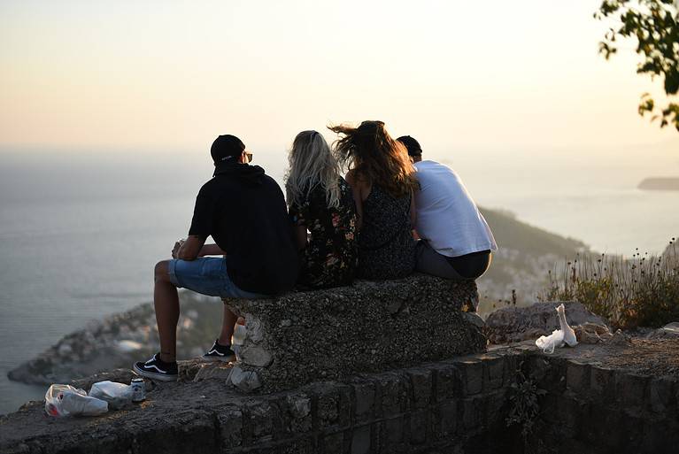 friends sitting on a rock