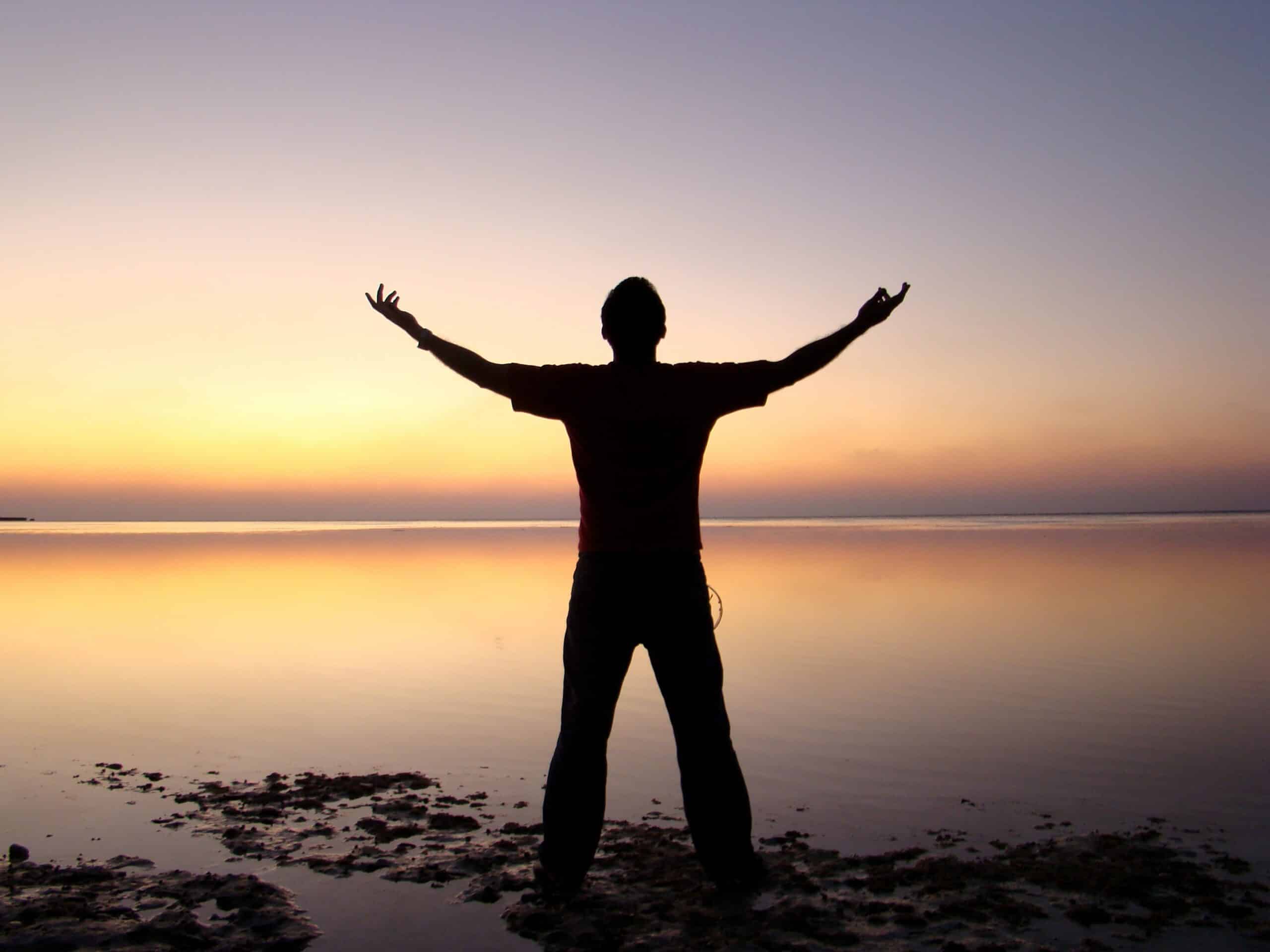 man sitting near lake