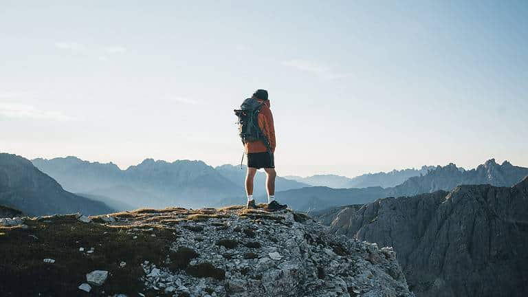 man climbing mountain