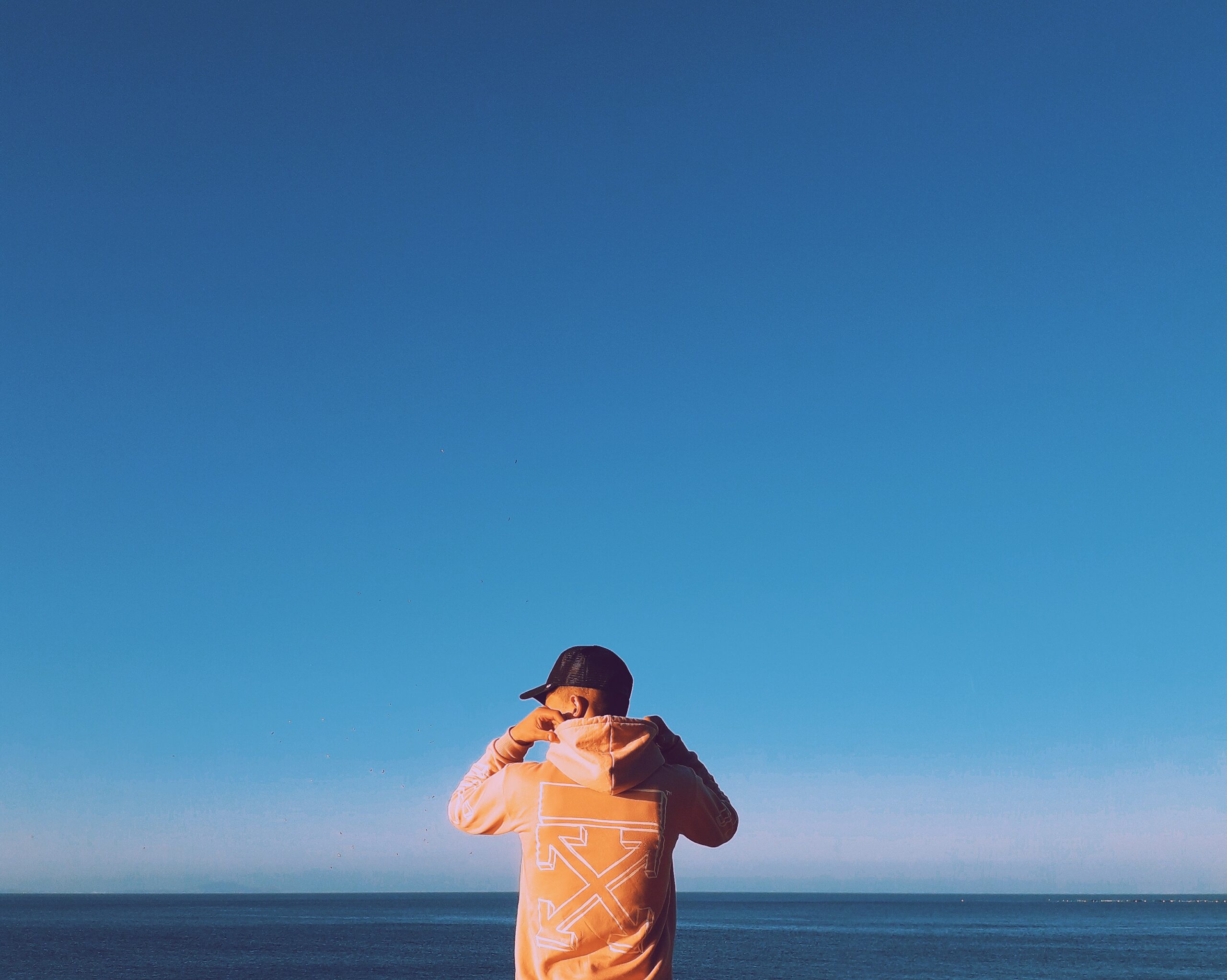 man staring into the ocean