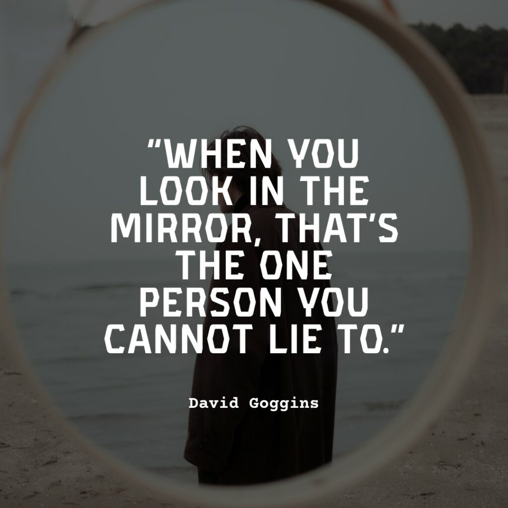 man staring into mirror