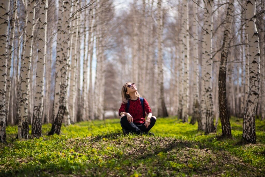 woman meditating in the forest