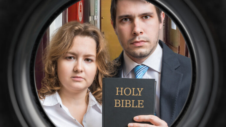two stern people holding a bible