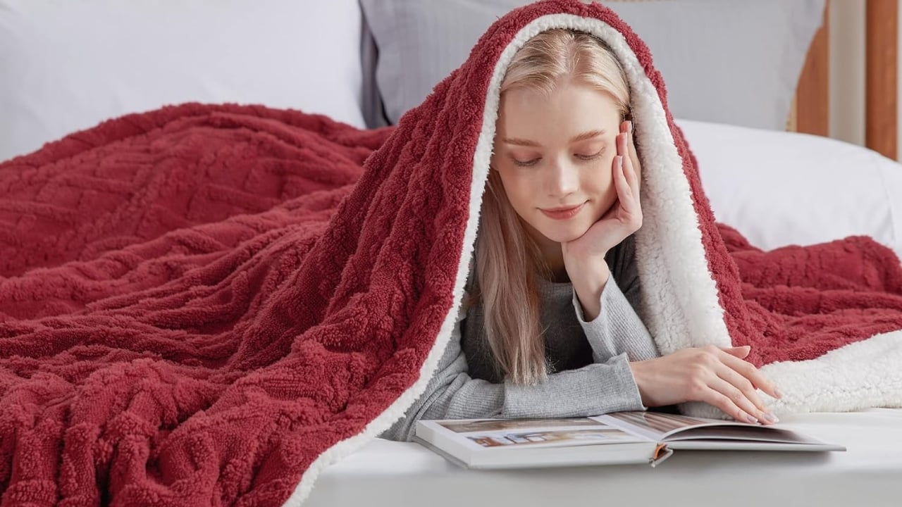 Woman in bed under blanket, warm, reading, cozy, comfortable