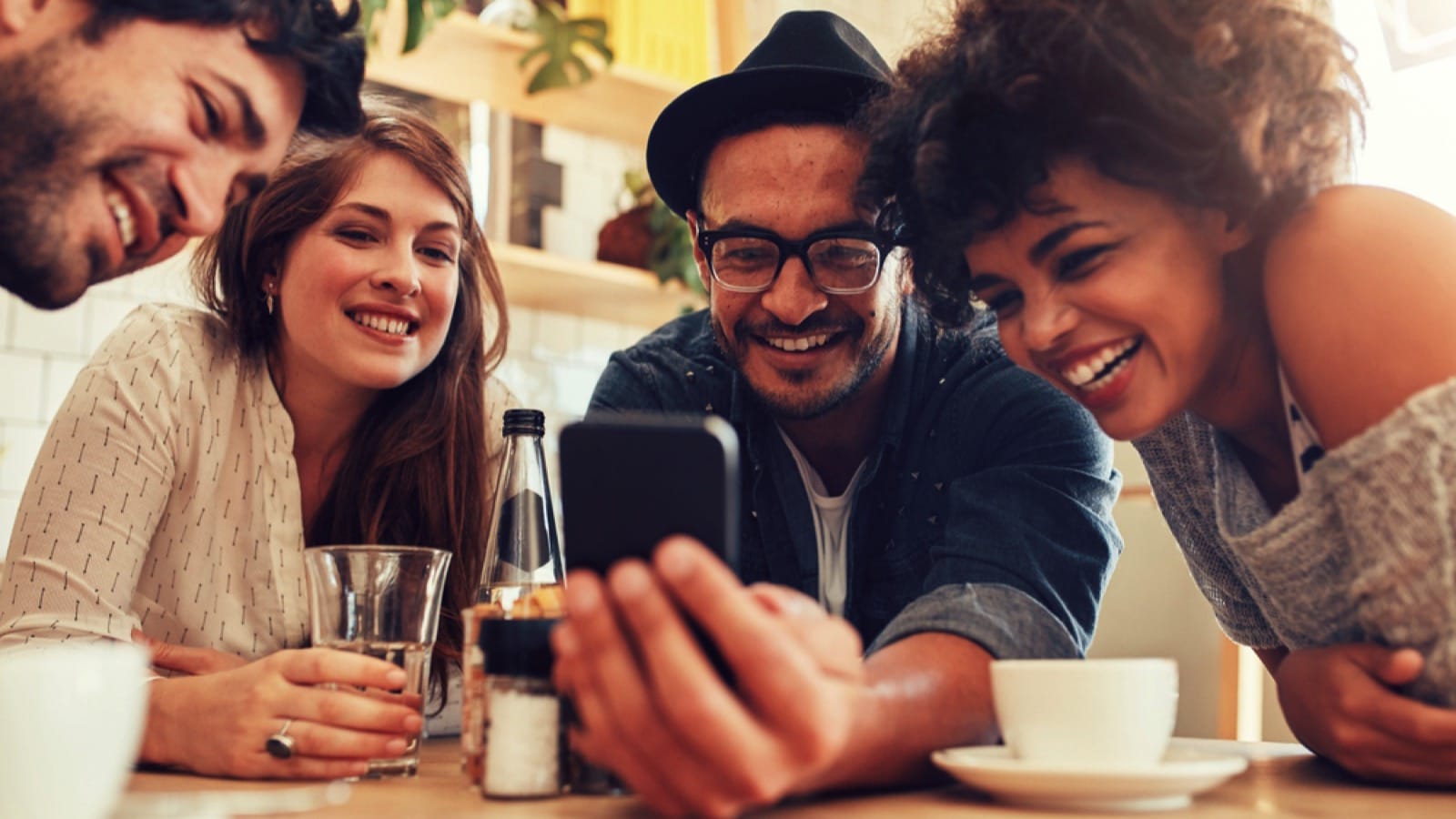 Friends seeing mobile and laughing