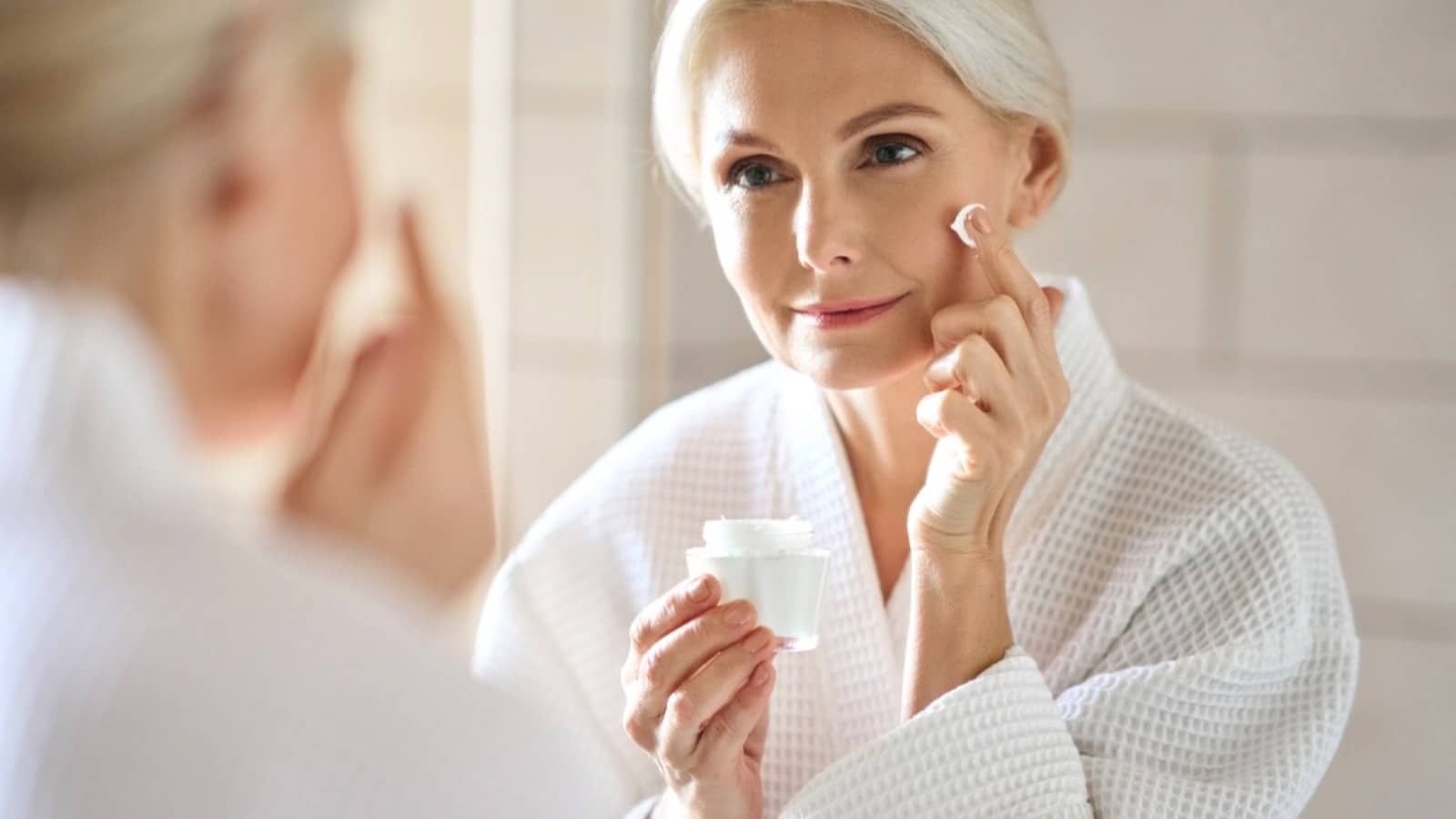 Middle age woman looking at skin