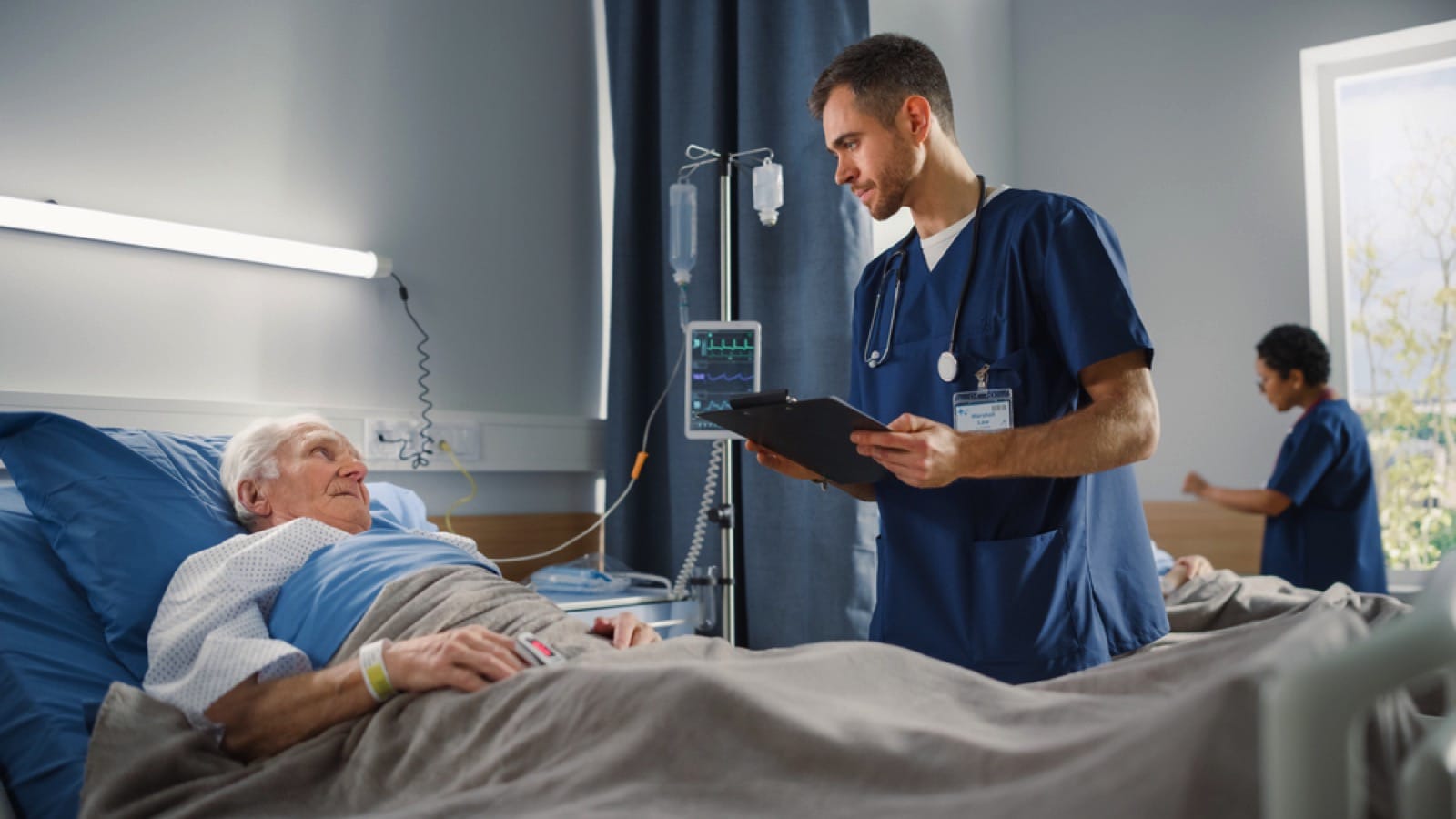 Old man talking to nurse