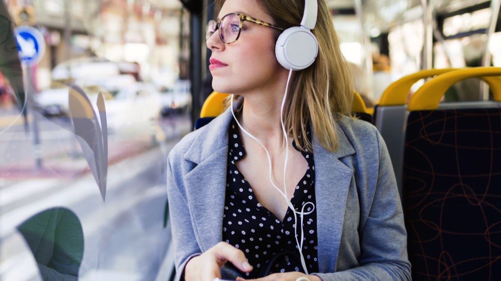 Woman traveler using wired headphones