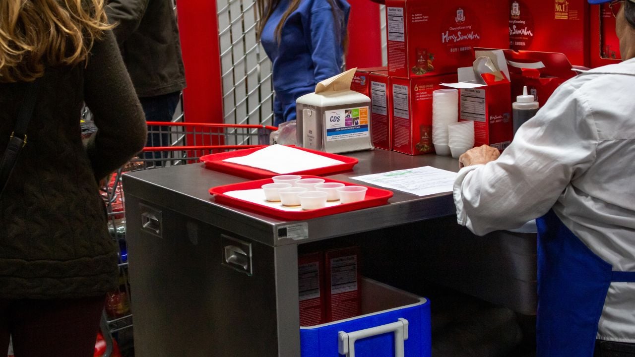 Costco samples next to an employee.