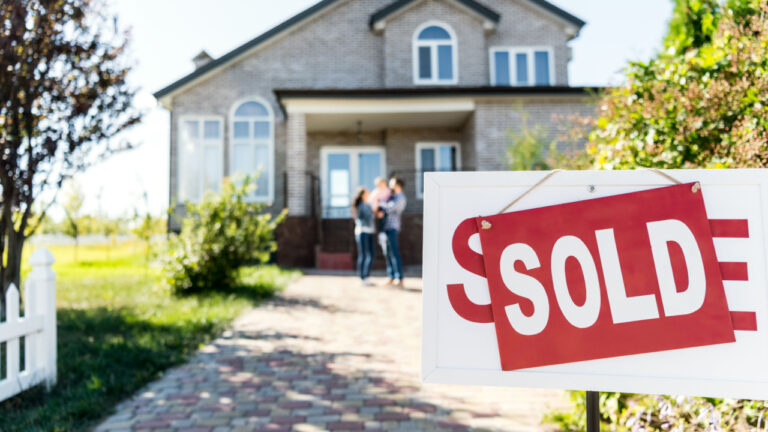 sold house with blurred family on background