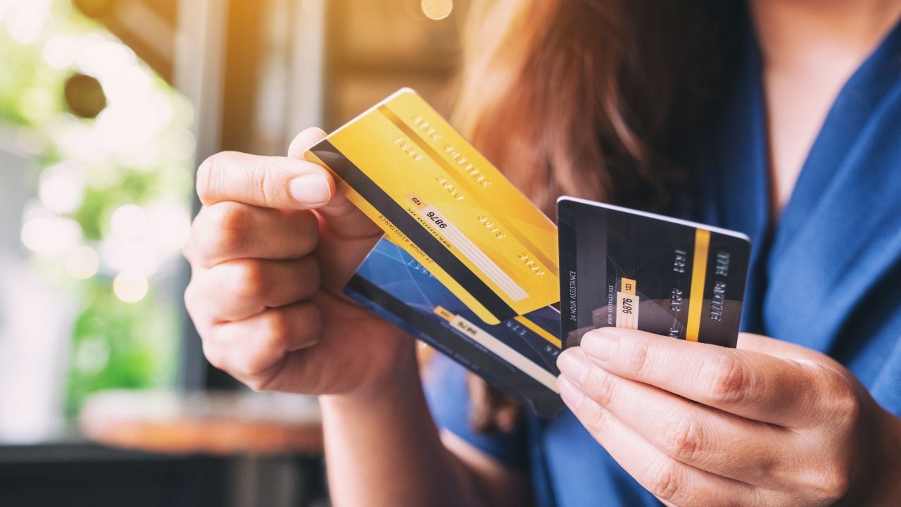 Closeup image of a woman holding and choosing credit card to use.