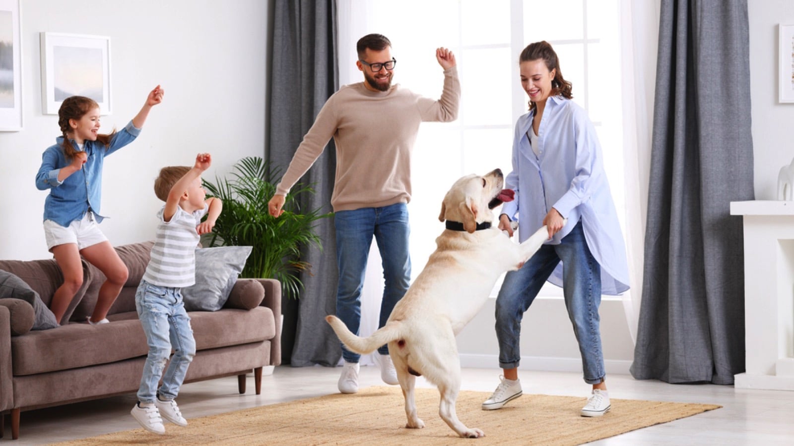 family dancing with dog.