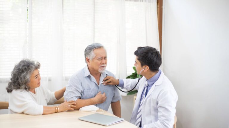 Older man at a doctor appointment checking on current health