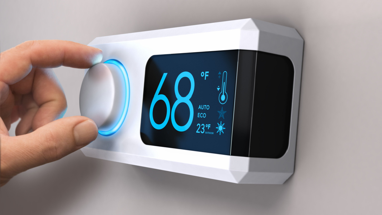 Hand turning a home thermostat knob to set temperature on energy saving mode. fahrenheit units. Composite image between a photography and a 3D background.