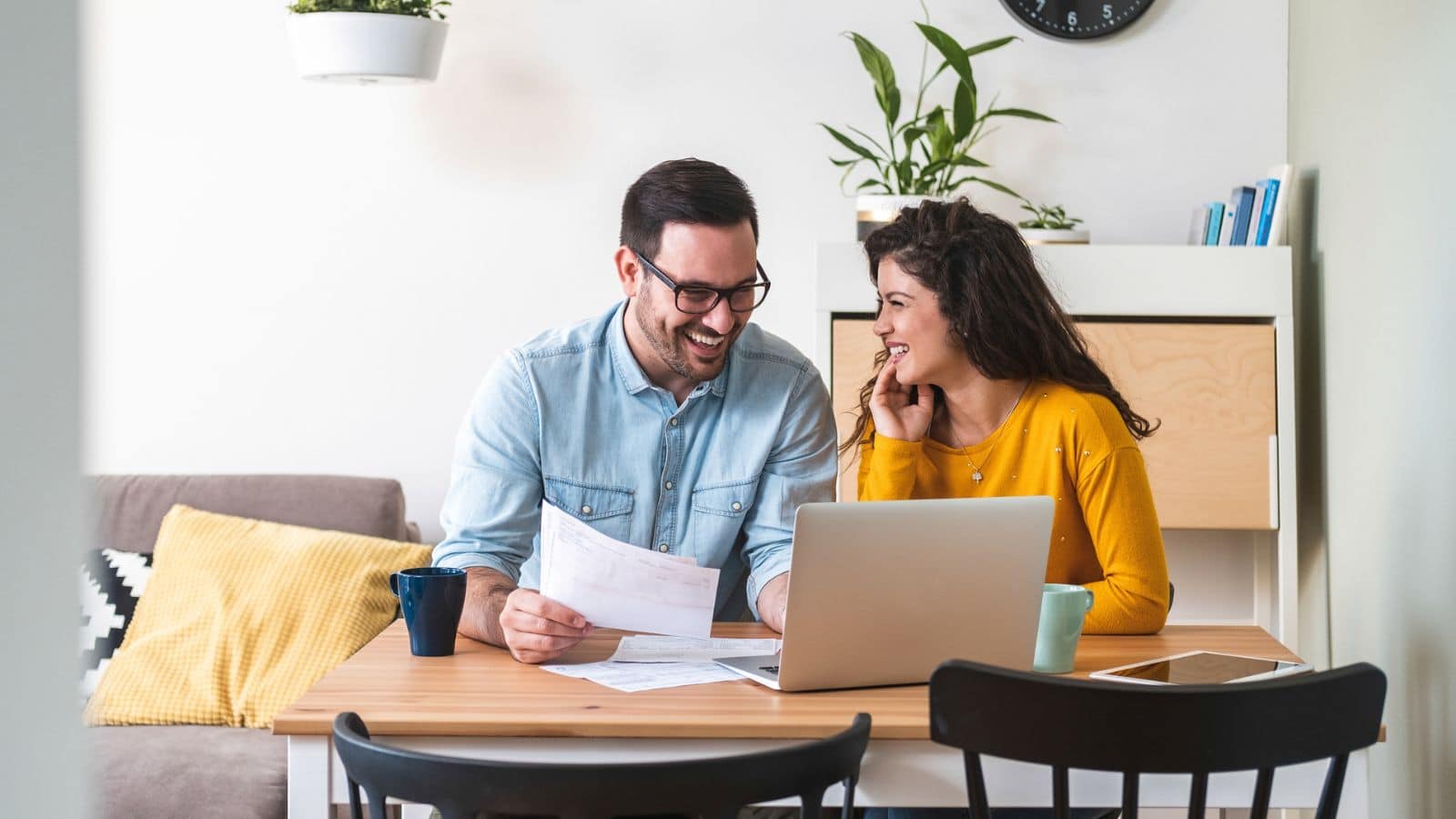 Couple working on computer reviewing finance.