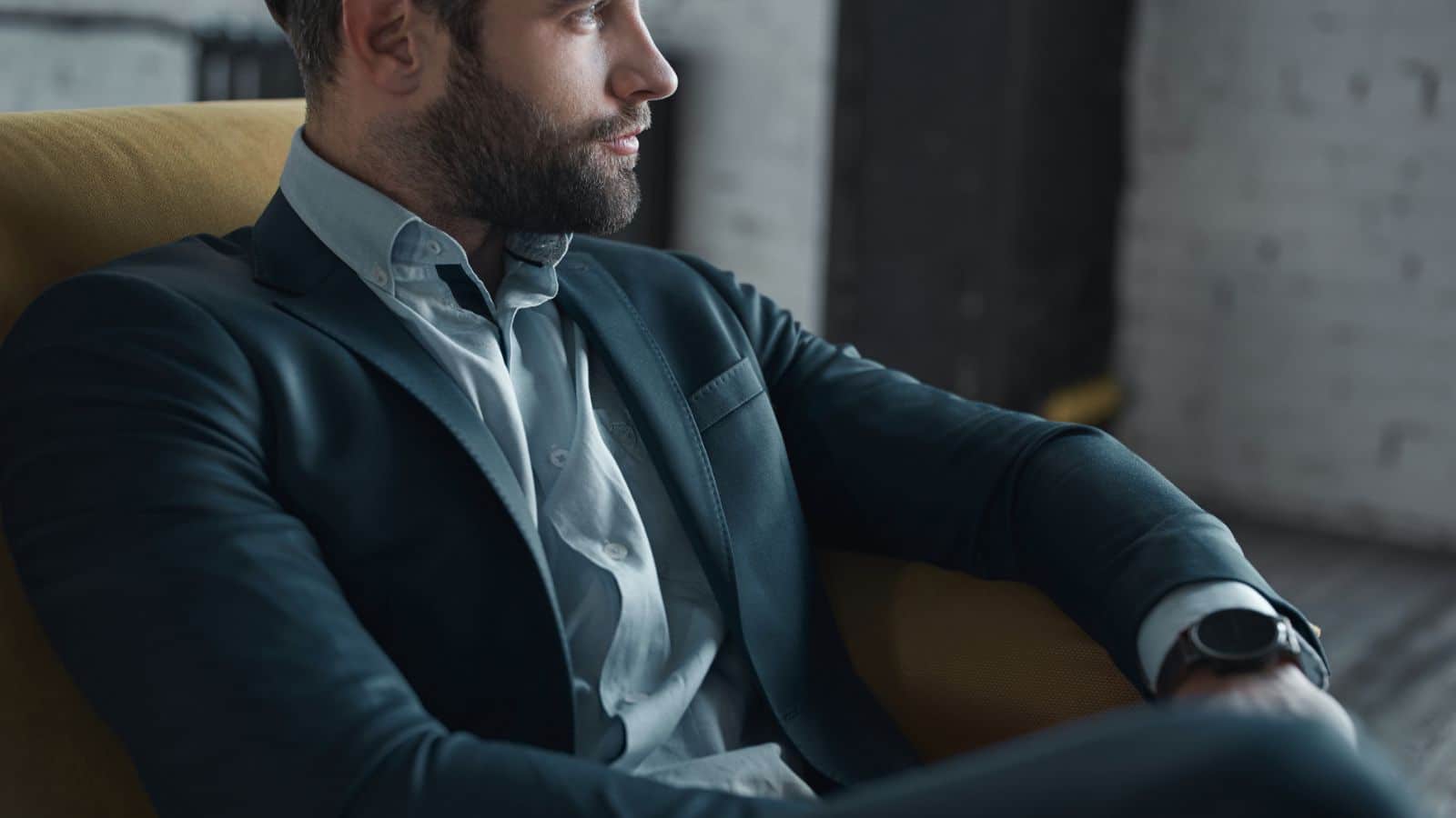 Rich man sitting in chair close-up.