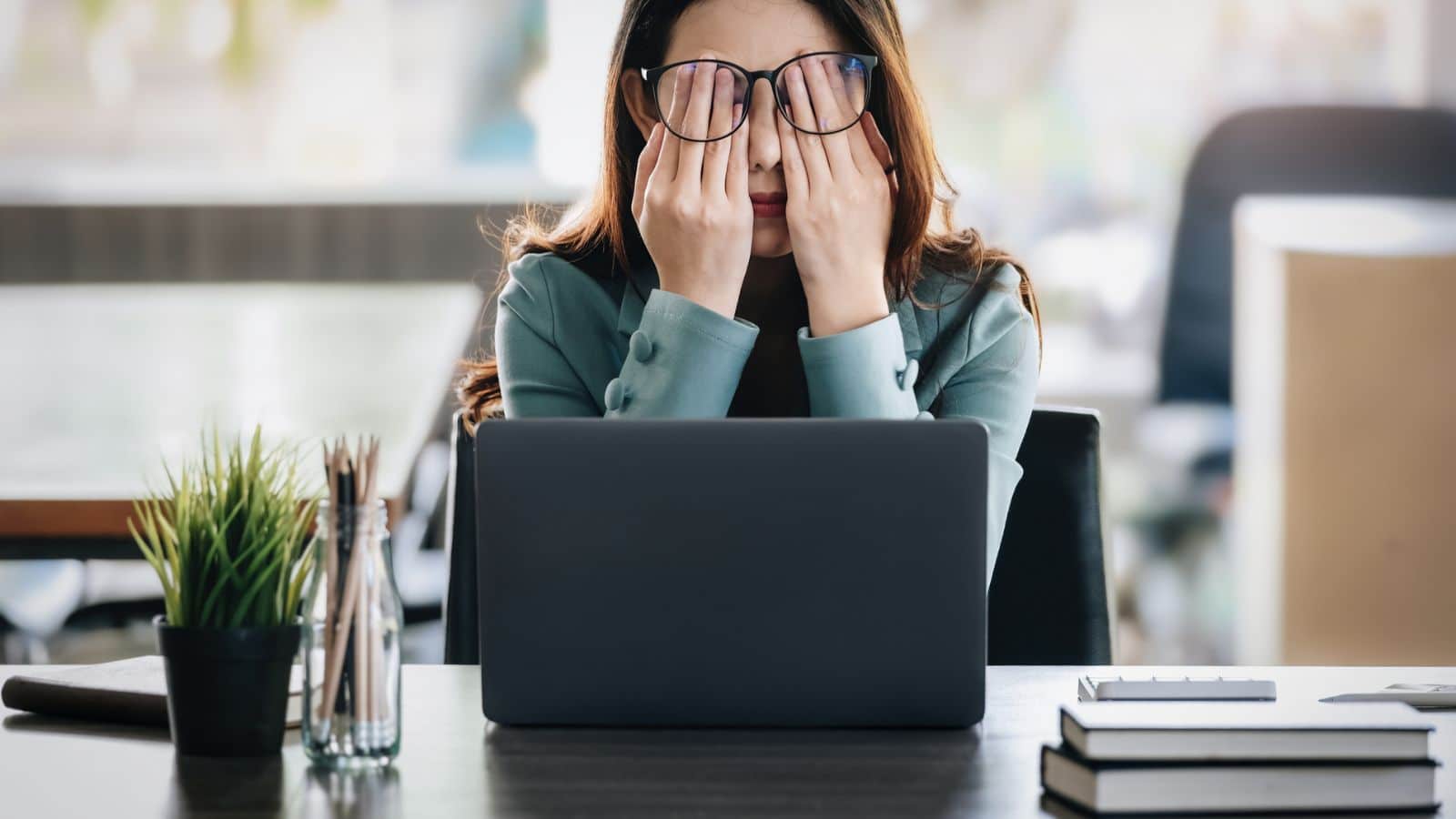 Business woman feels stressed and burned out working.