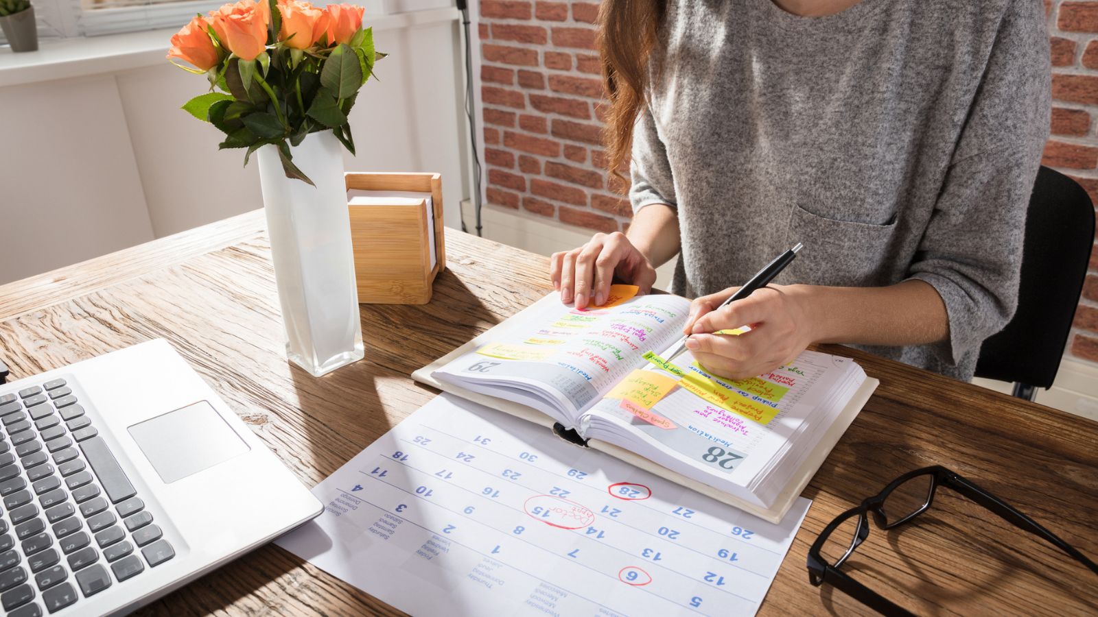 Businesswoman Making Schedule On Personal Organizer
