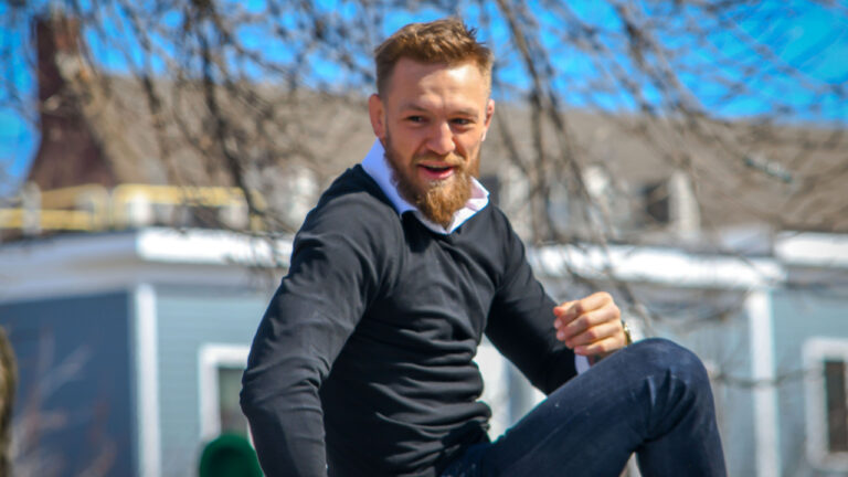 MMA fighter Conor McGregor rides atop a car in the St Patrick's Day Parade