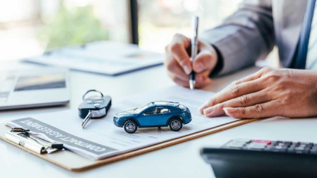 Man signing car rental insurance