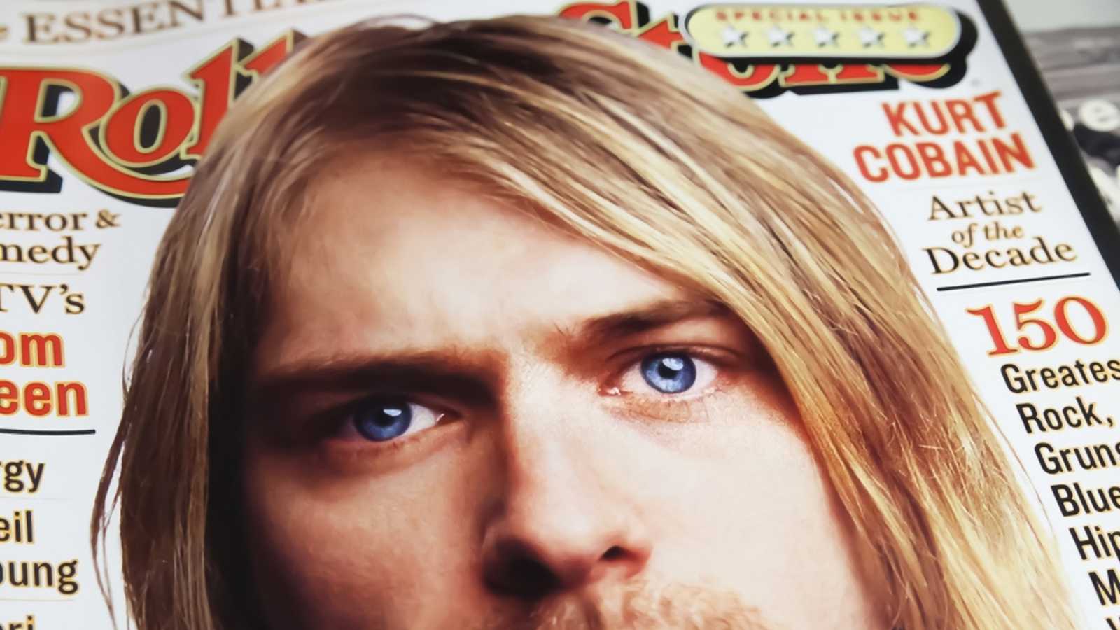 Closeup of rolling stone magazin cover with portrait of Nirvana singer Kurt Cobain in the 90s (focus on center)