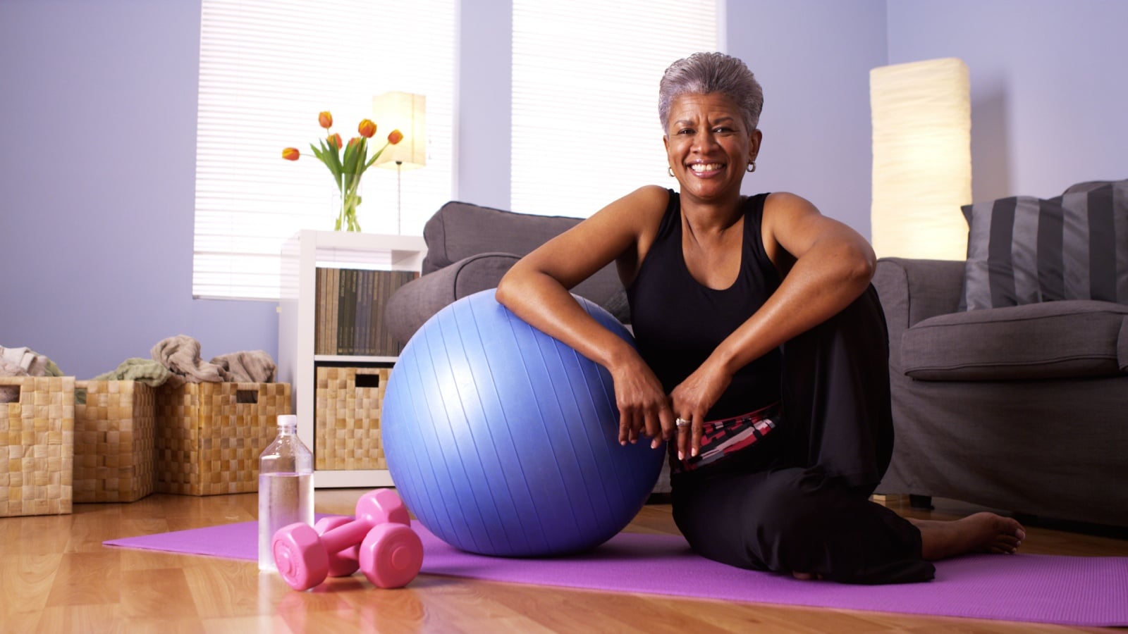 Older woman working out doing yoga.