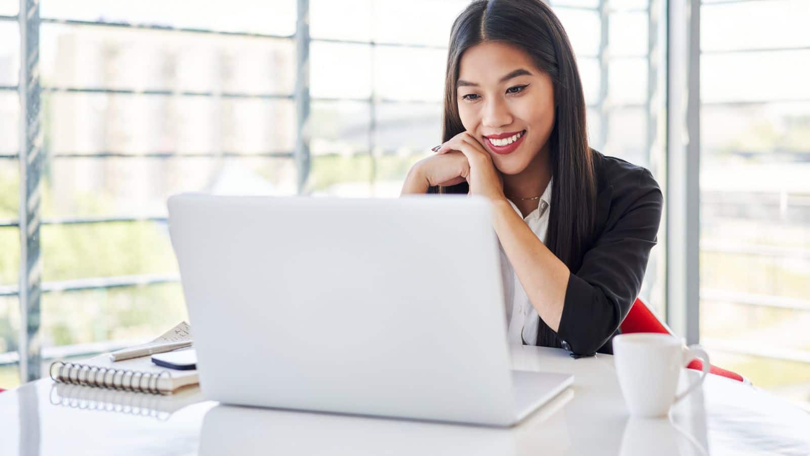 Young woman on virtual meeting smiling and grateful.