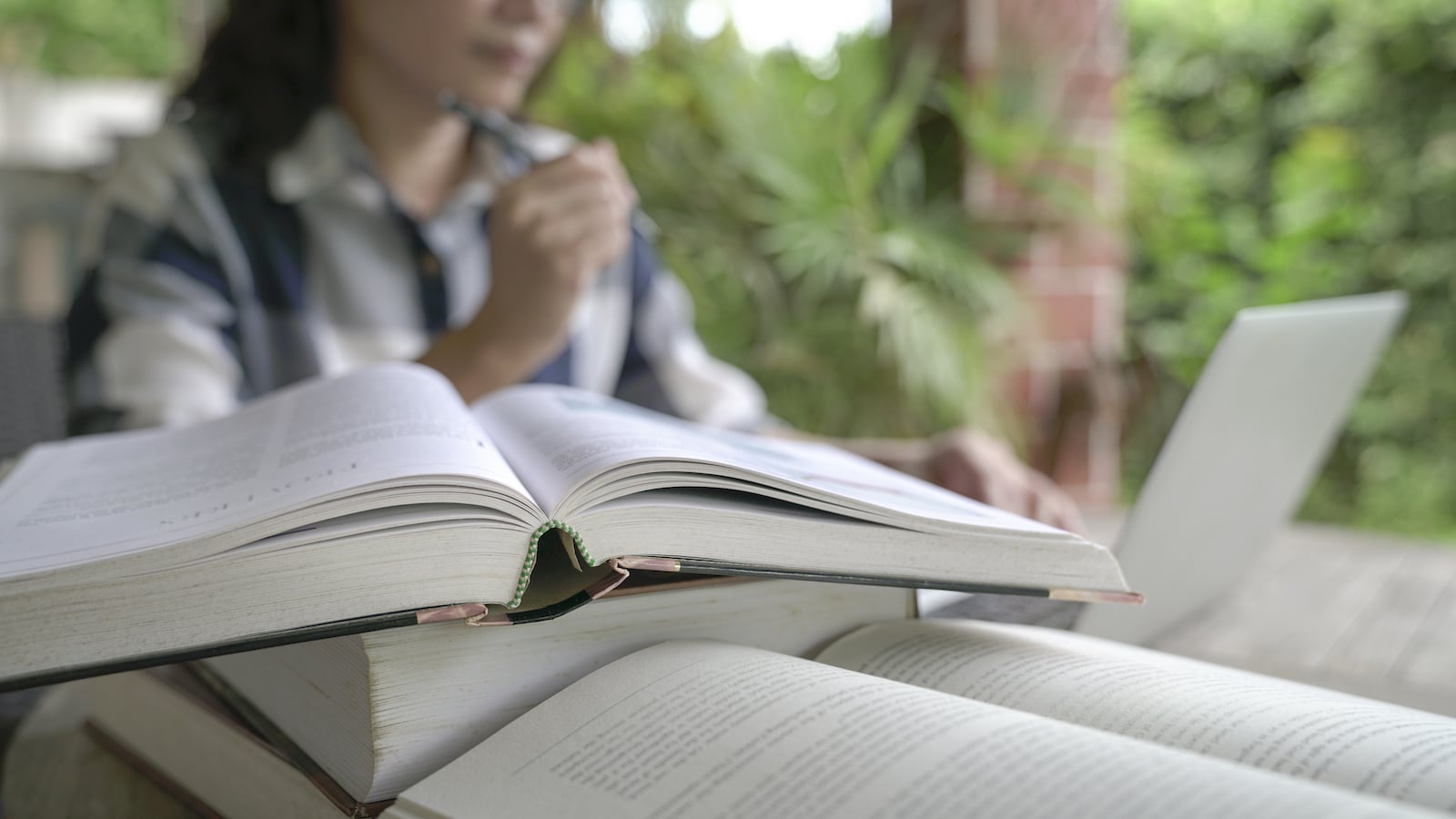college student studying with lots of books.