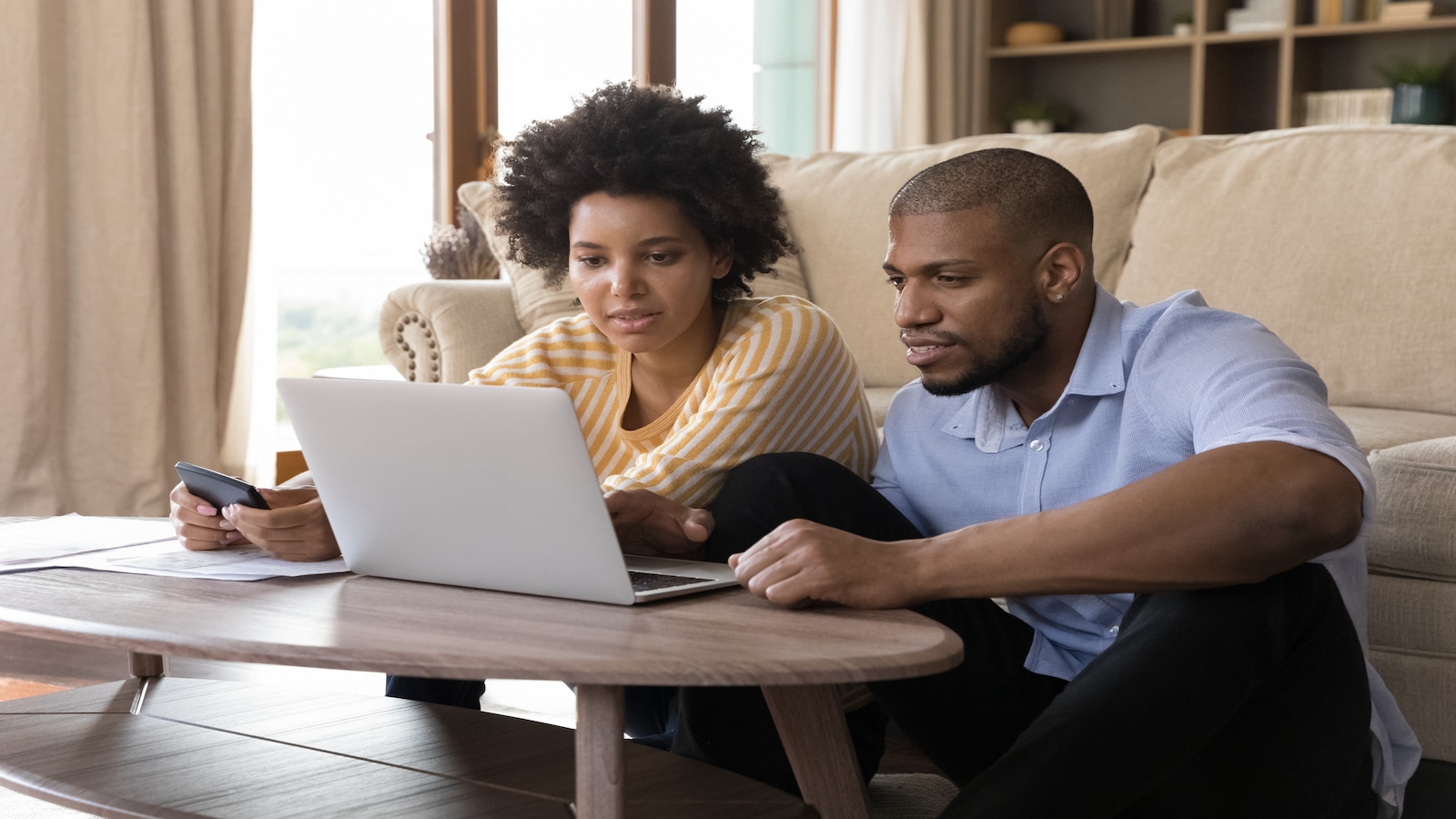 couple looking at investments automatic investing on computer.