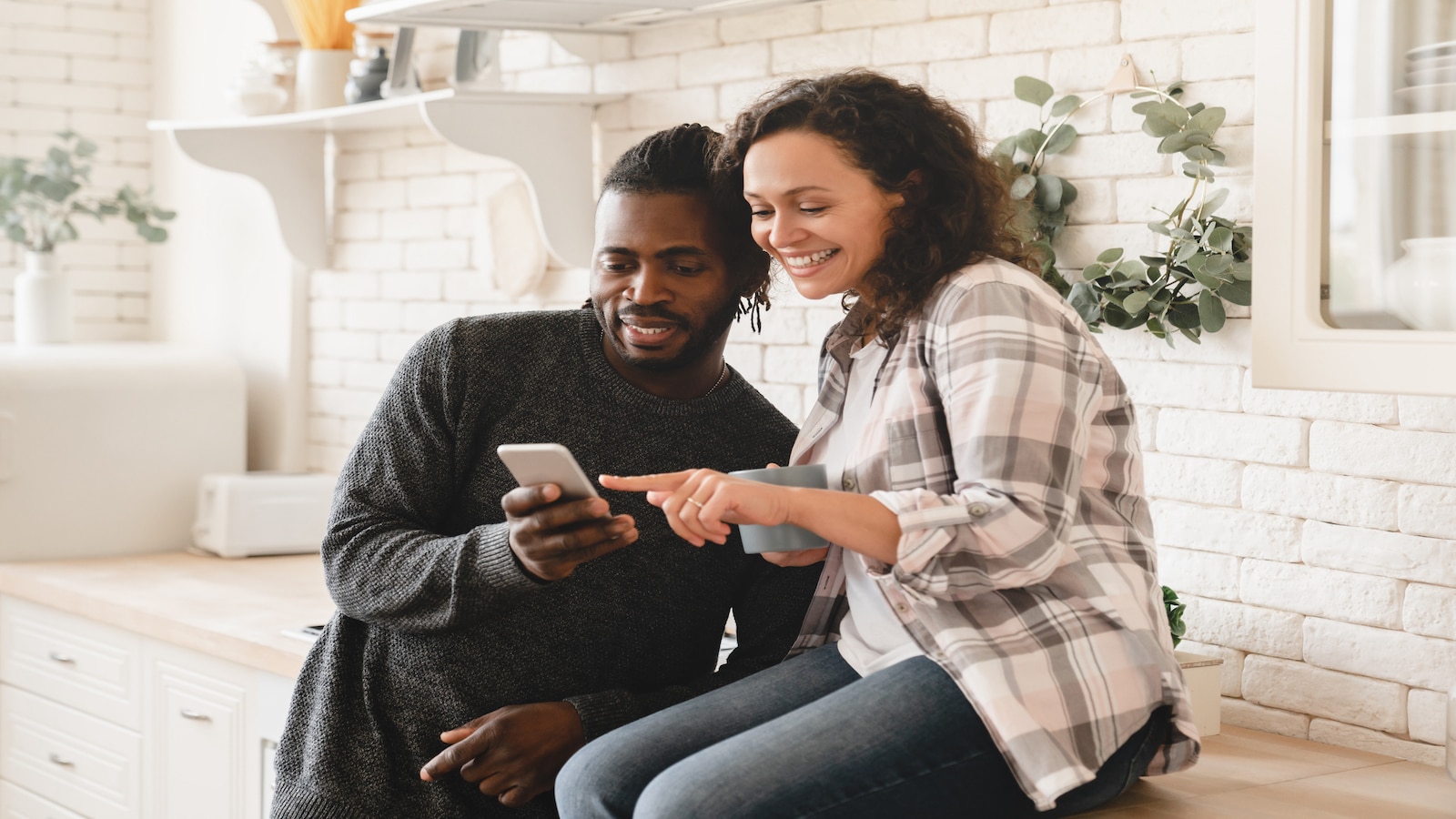 couple looking at phone together searching internet.