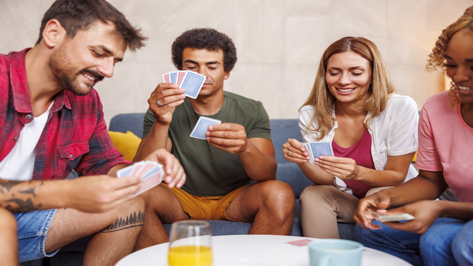 Friends having fun playing card games at home.