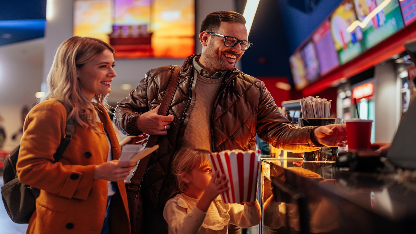 family getting food at theater show or movies.
