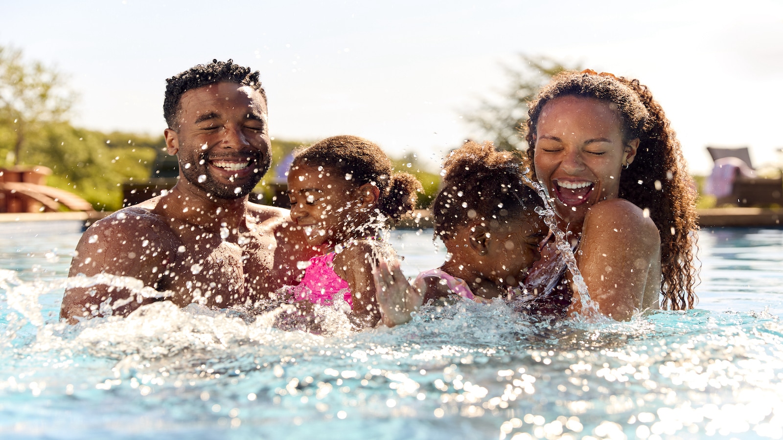 family in pool together.