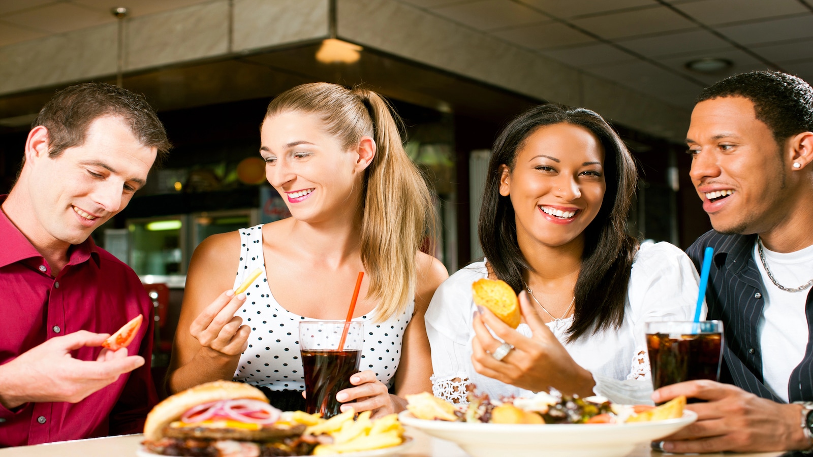 Friends eating dinner together happy.