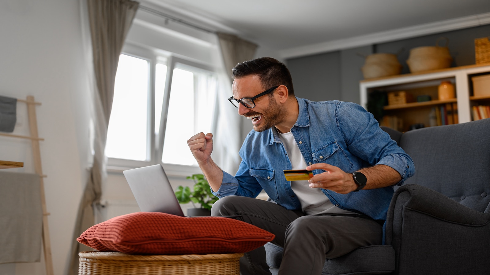 Man excited using credit card.