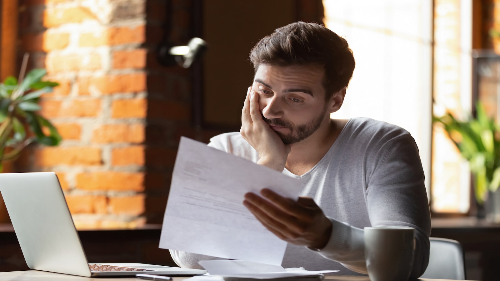 confused frustrated man in cafe