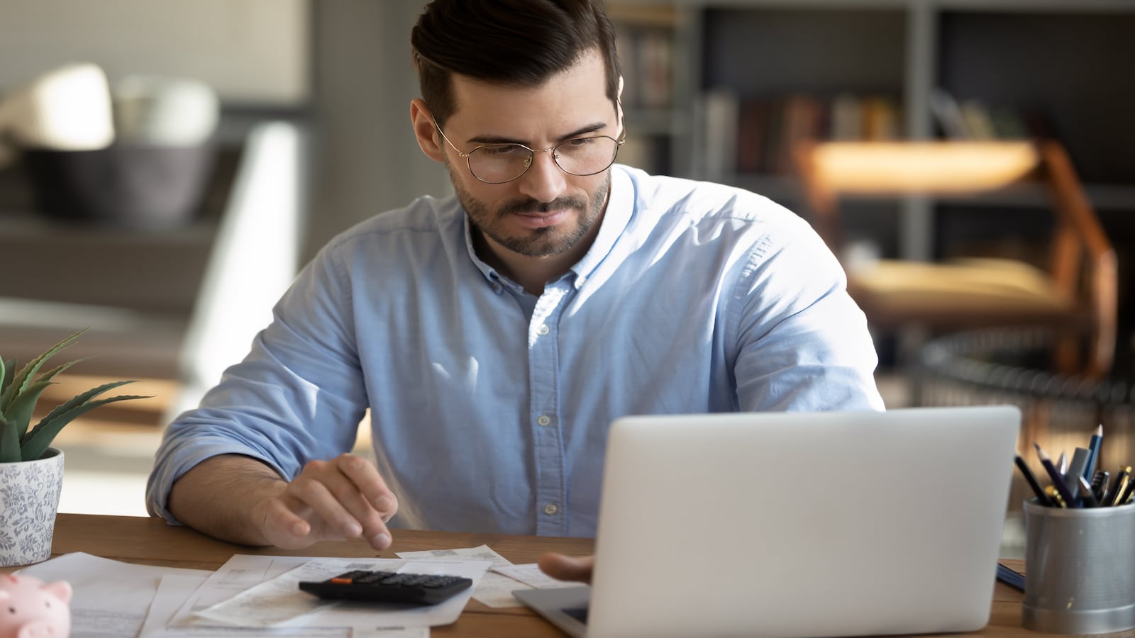 man working on computer paying bills.