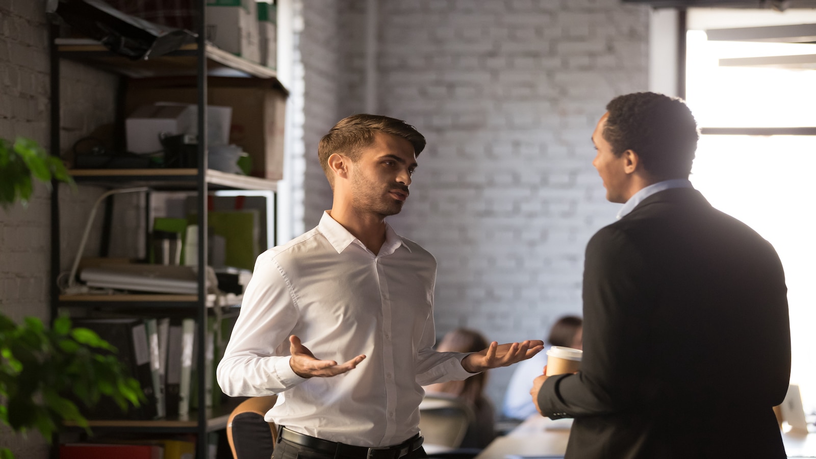 men talking at work.