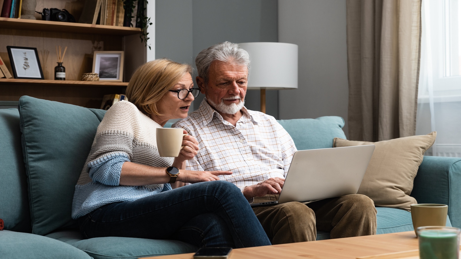 older couple looking at bills on computer.