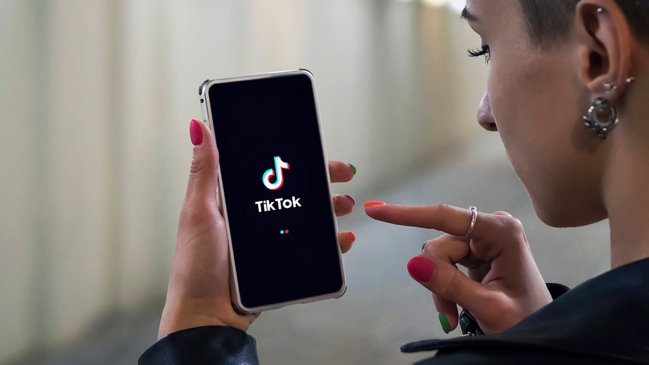 A person using TikTok on their phone.