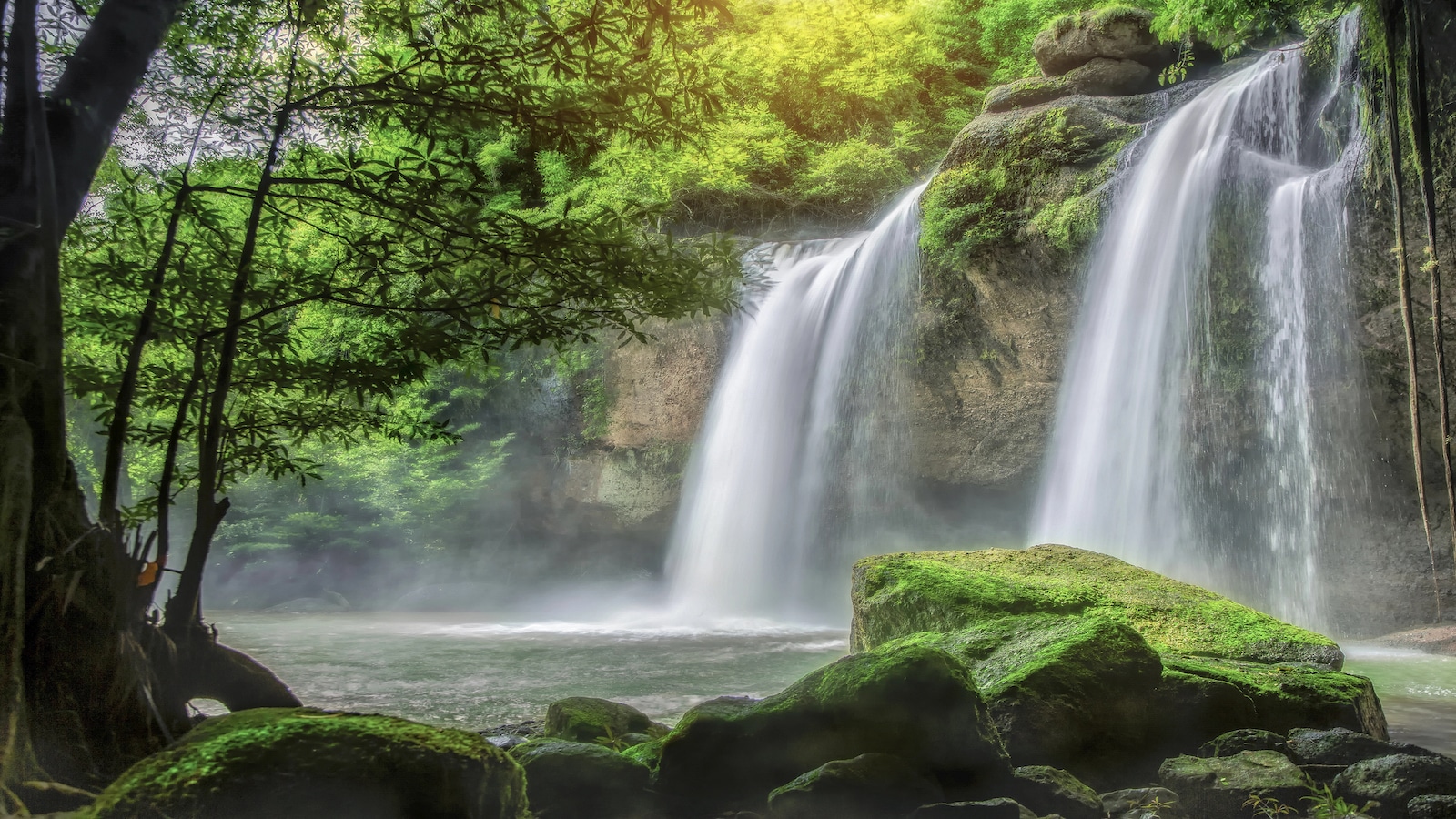 Waterfall in forest in Thailand on sunny day.