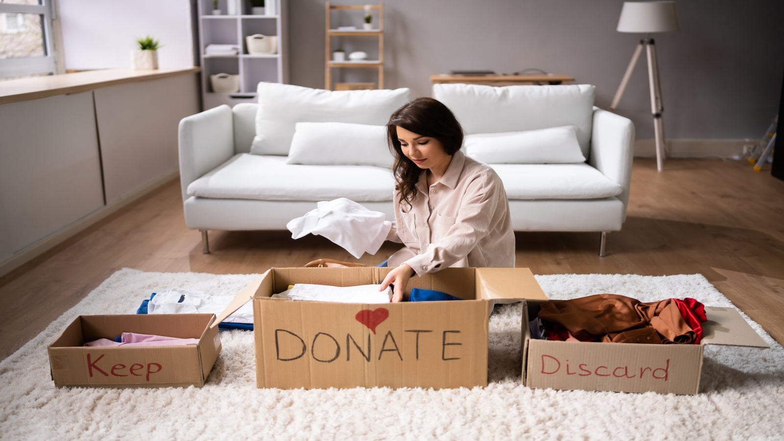 Woman Donating Decluttering And Cleaning Up Wardrobe.